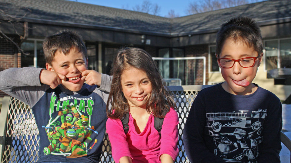 The Harding triplets sitting outside
