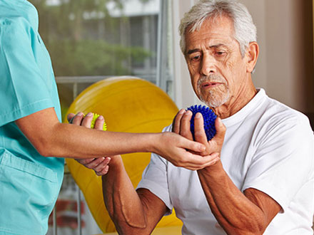 Man holding a ball in Outpatient Therapy