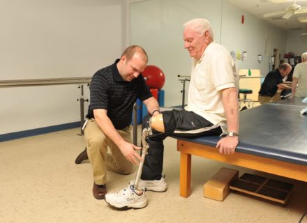 Amputee patient getting fitted with prosthetic