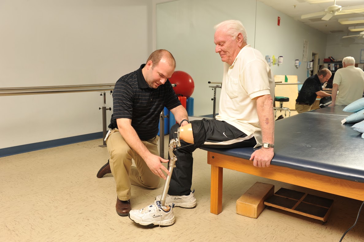 Amputee patient getting fitted with prosthetic