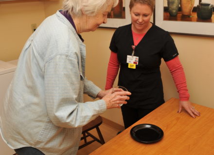 Patient in kitchen setting table