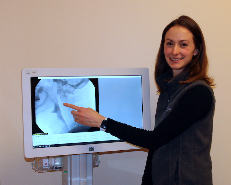 Patient looking at results of modified barium swallow study