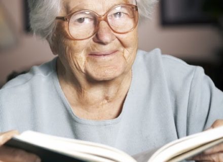 Elderly woman reading a book,