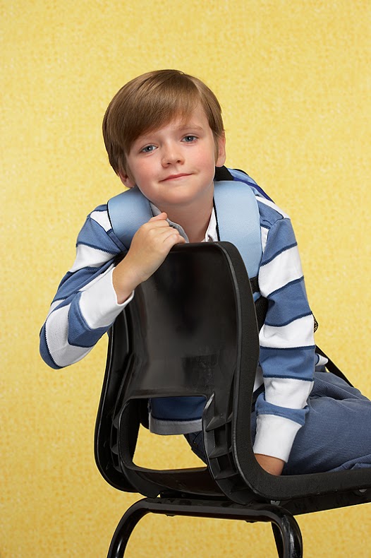 Young boy sitting in chair