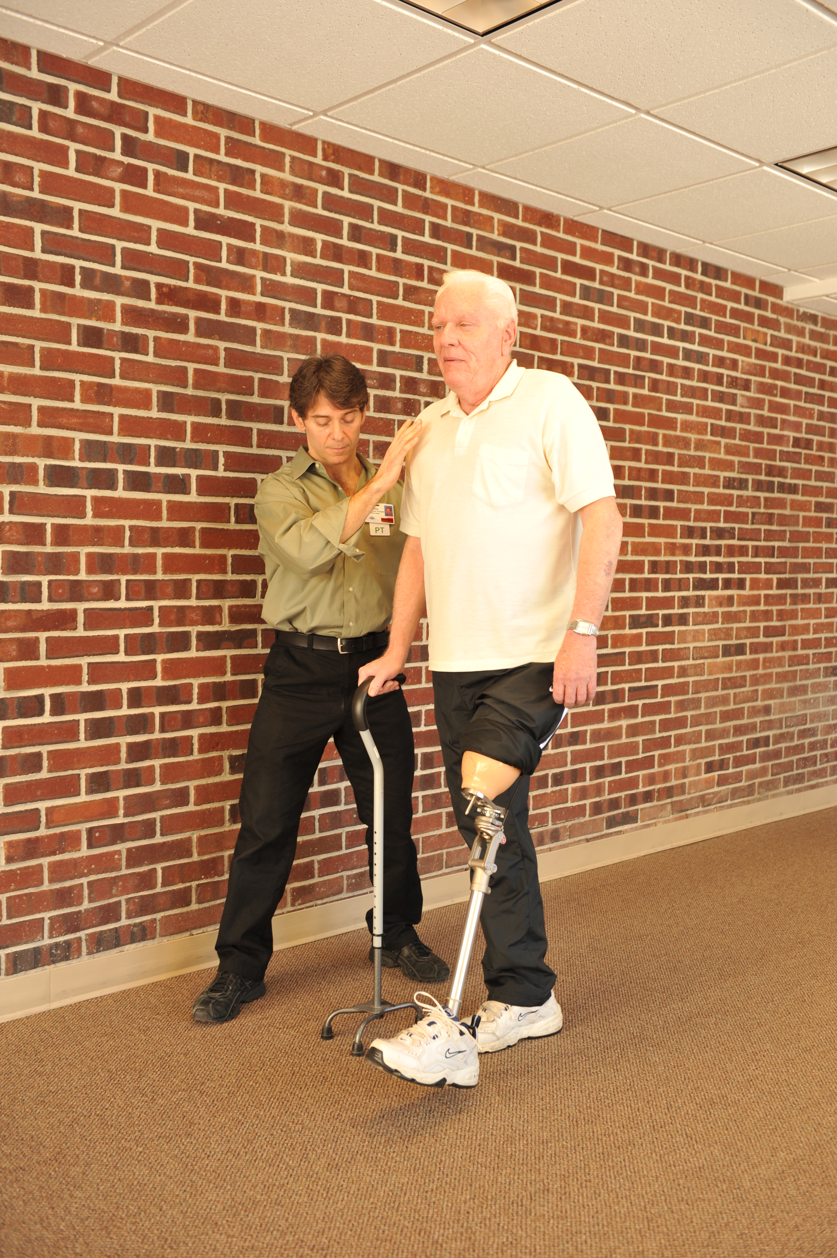 Patient with amputation walking with therapist