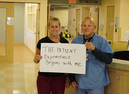 Staff holding sign about patient experience