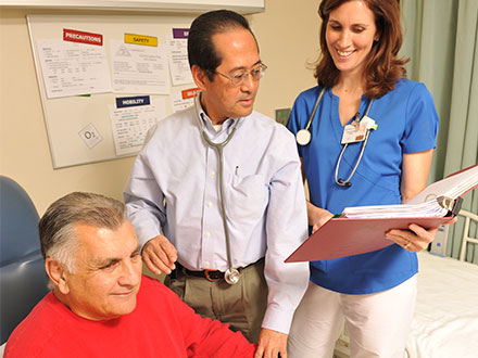 Nurse and doctor with patient