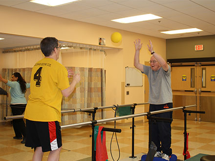 Patient throwing ball to therapist