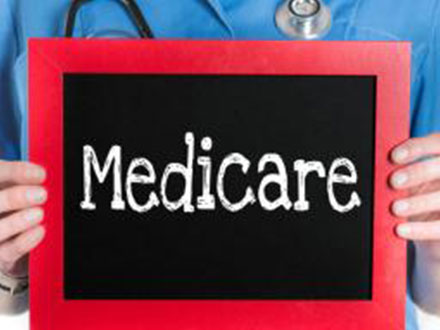 Nurse holding medicare sign