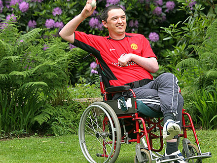 Brain injury survivor throwing a ball