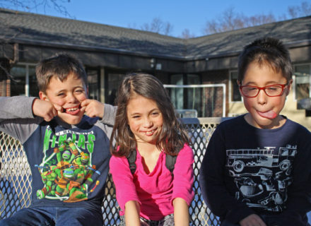 The Harding triplets sitting outside