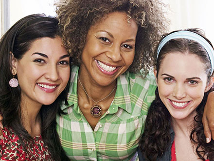 Three women friends smiliing