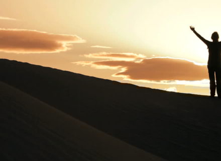 Woman celebrating at sunset