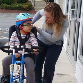 Vraj riding his adaptive tryke