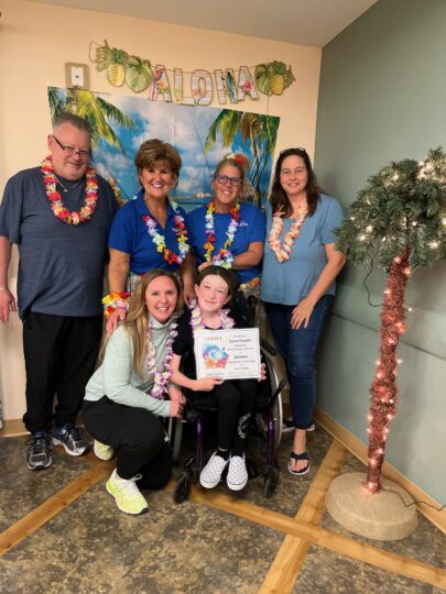 Photo of Shianne, her parents, the Make-A-Wish granters and her Northeast Rehab therapist.