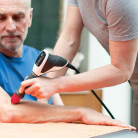 Photo of someone receiving shockwave therapy for their elbow.