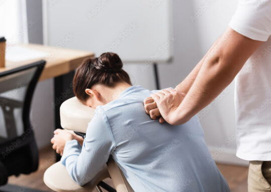 Picture of someone sitting in a massage chair receiving a massage.